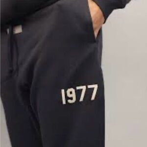 Essentials Black Jogger Pants with '1977' Graphic- fear of god